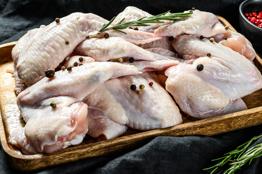 Pastured turkey wings near me, non-GMO, local NC farm fresh turkey, shown raw on a wooden tray