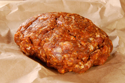 Local Pork Chorizo from Carolina Pastures Farm, raw on a piece of brown paper