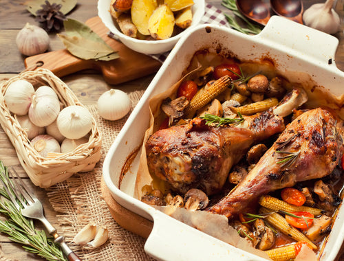 Roasted pastured non-GMO turkey drumsticks in a ceramic dish